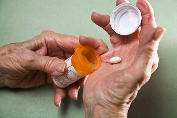 elderly person taking pill 1