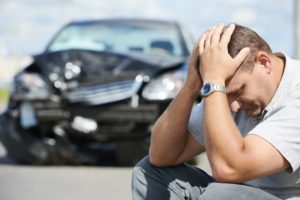 man distressed over car wreck