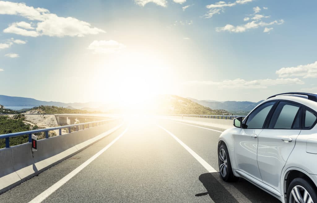 car driving on sunny road