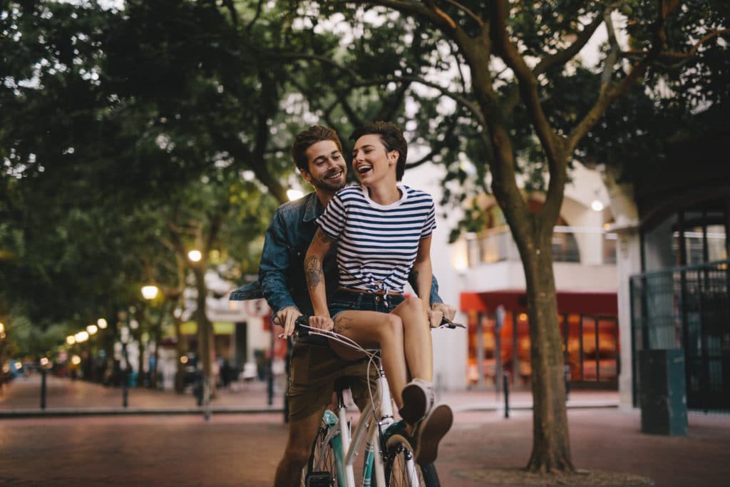 Woman riding on bicycle handlebars