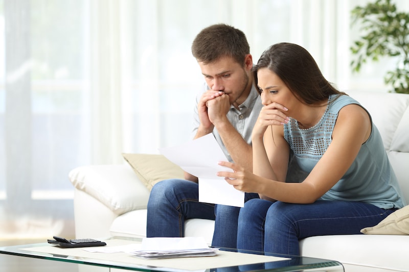 Worried couple looking at denied claim