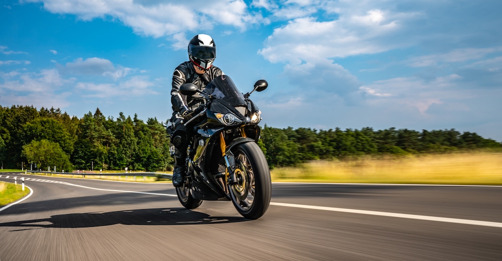 Man riding a motorcycle on a sunny day