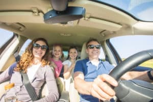 family with children is traveling in a car on a journey. 300x200 1