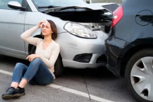 Injured girl after car accident in the street