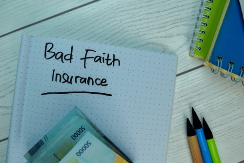 Bad Faith Insurance write on a book isolated on office desk