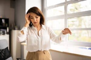 A woman with a brain injury touching her head