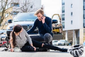 A man calling for help after a woman was injured in a dooring bicycle accident