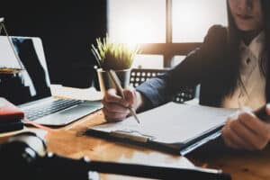 A Boulder legal malpractice lawyer reviewing contracts at her desk