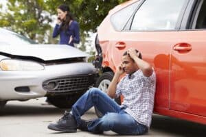 Man and woman on the phone after a Lyft accident i Co