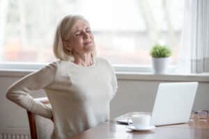 Woman with a back injury holding her lower back